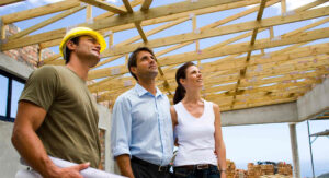 Couple discussing building plans with contractor