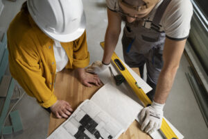 Two people looking at the commercial building remodeling plan