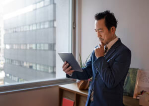 A businessman carefully checks a reputable contractor to select for a project