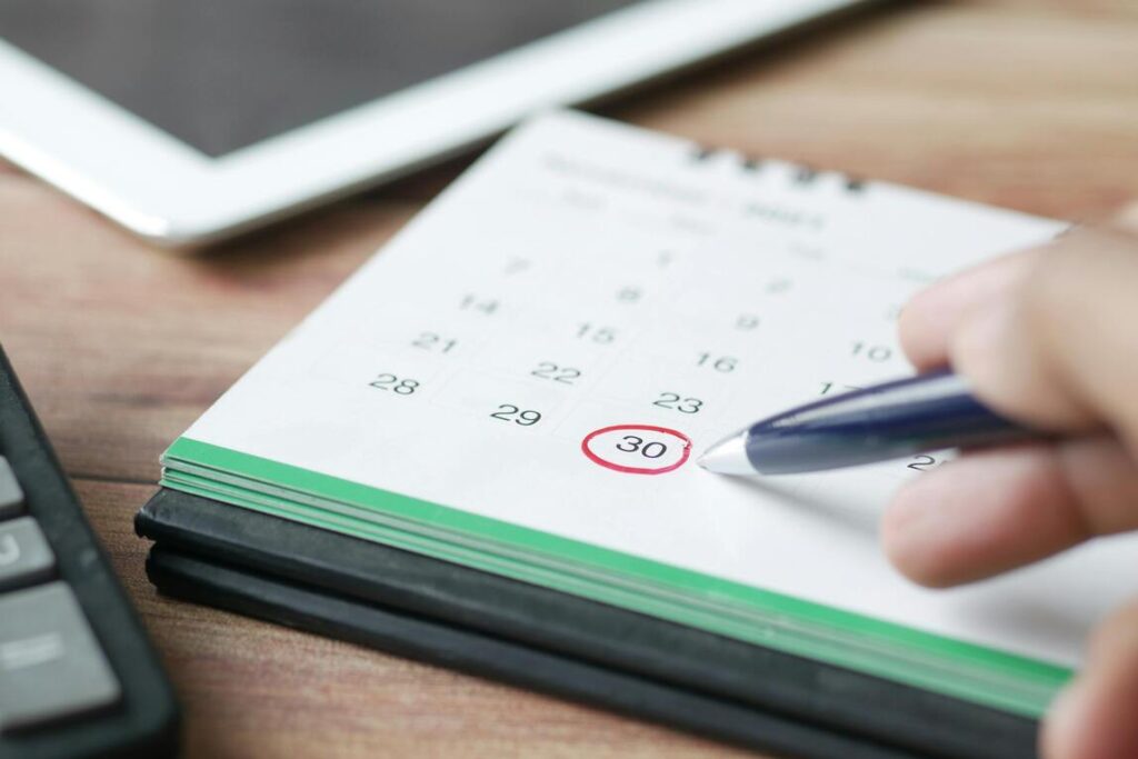 A person marking a day on a calendar