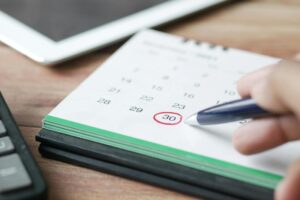 A person marking a day on a calendar