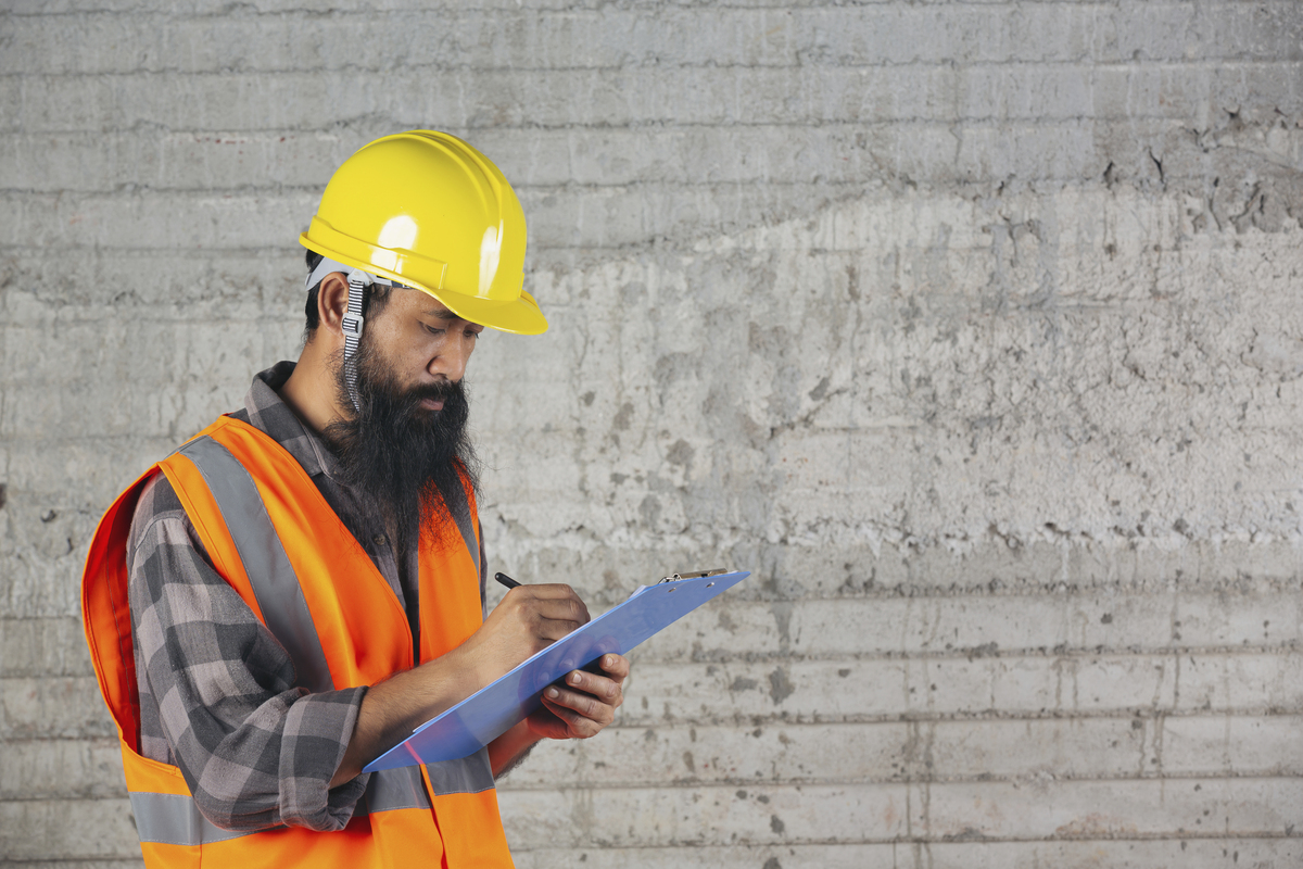 A man writing about the progress of the construction 